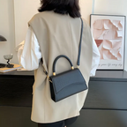 Stylish PU leather handbag featuring a top handle and a detachable crossbody strap, perfect for versatile wear and everyday use. 2