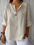 Elegant linen blouse featuring a flattering V-neckline and stylish roll tab sleeves, perfect for casual or dressy occasions. 0