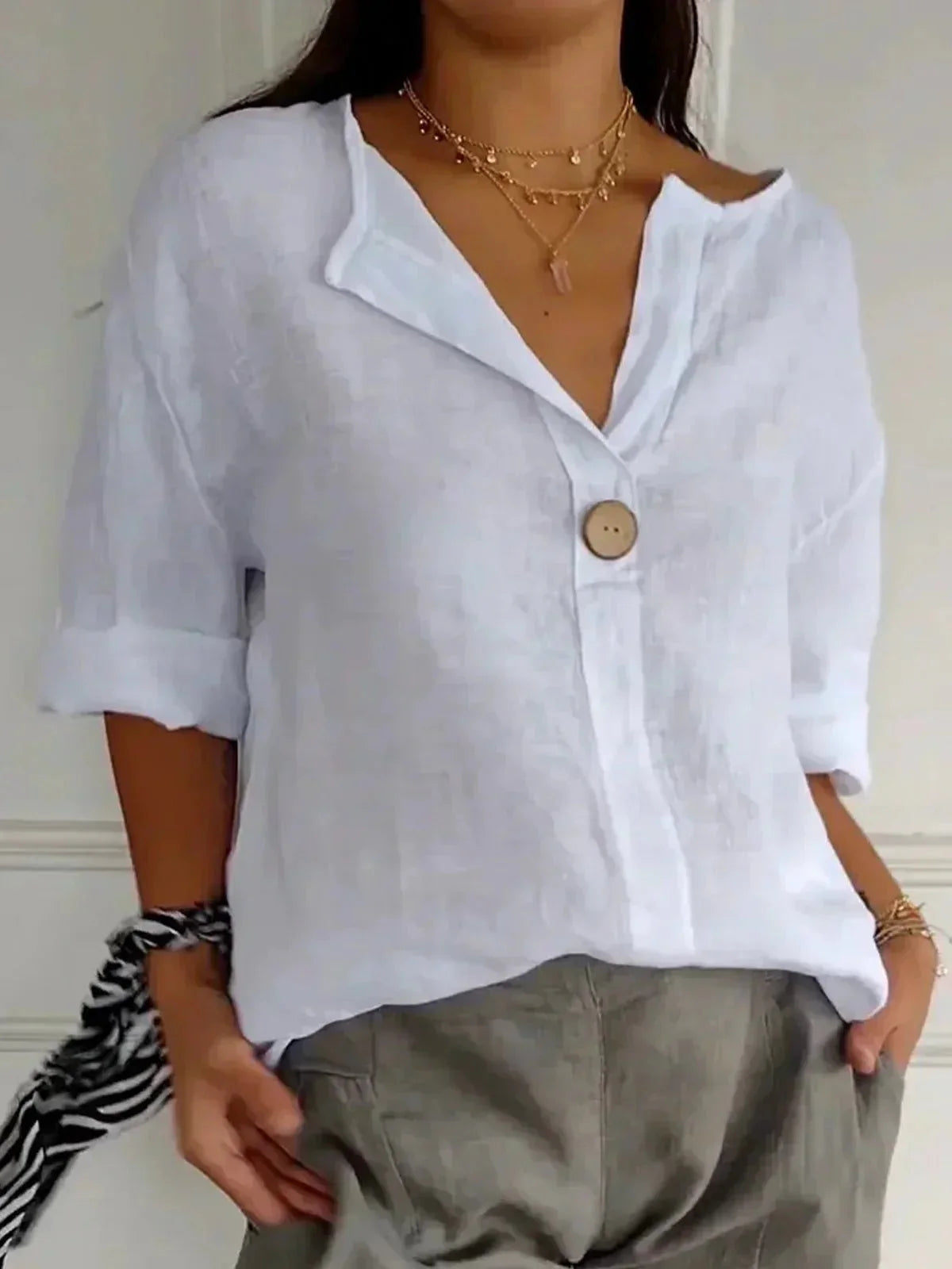 Elegant linen blouse featuring a flattering V-neckline and stylish roll tab sleeves, perfect for casual or dressy occasions. 2