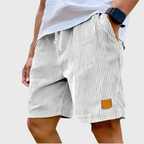 Men's relaxed fit textured summer shorts in a light color, perfect for casual occasions. Featuring a comfortable waistband and stylish design, ideal for warm weather outings 1