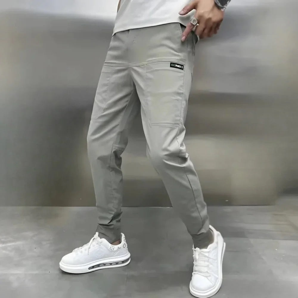 Men's slim fit cargo joggers featuring ribbed cuffs, designed for stylish casual wear, showcasing a modern silhouette and practical pockets. 0