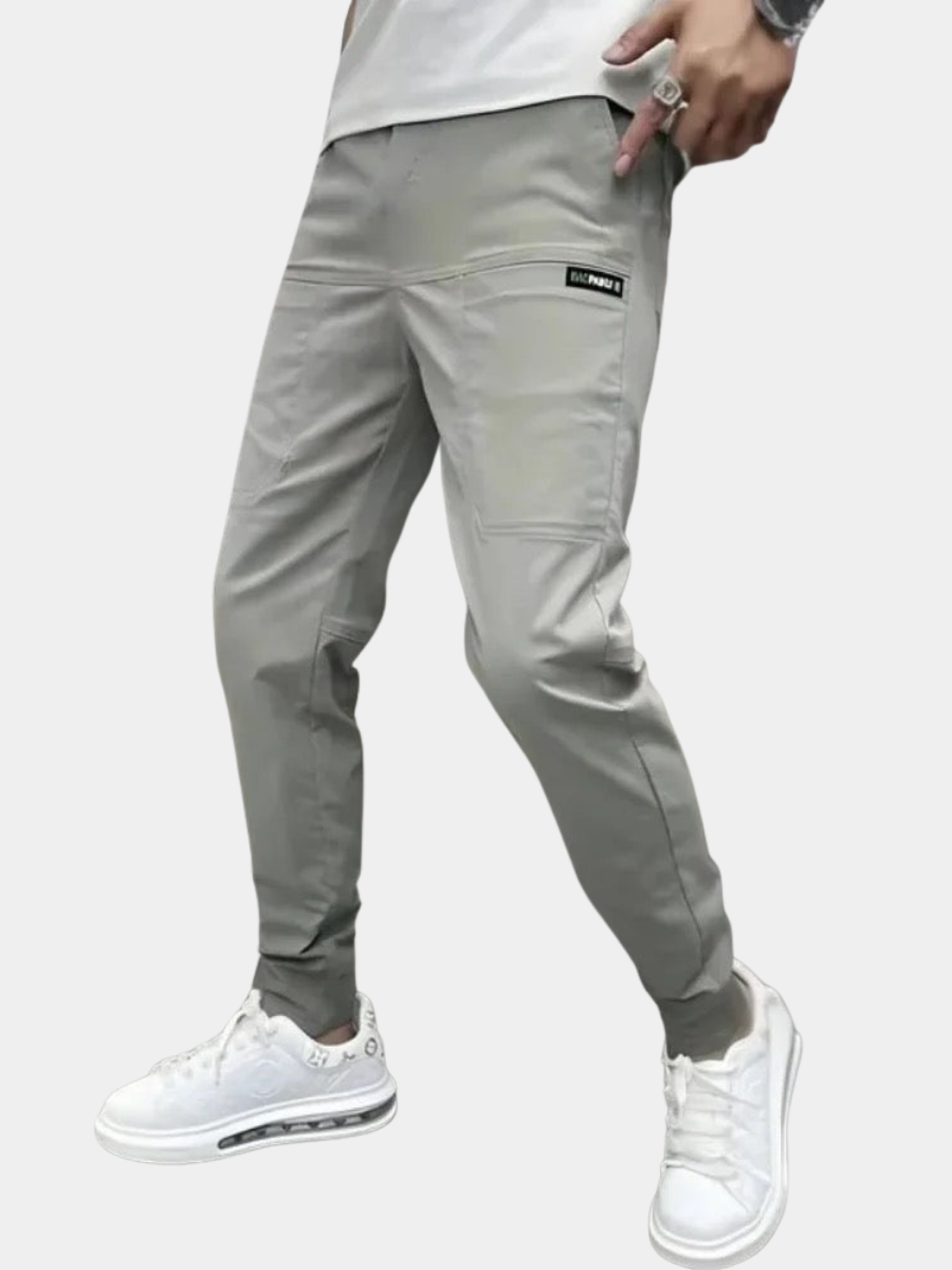 Men's slim fit cargo joggers featuring ribbed cuffs, designed for stylish casual wear, showcasing a modern silhouette and practical pockets. 1