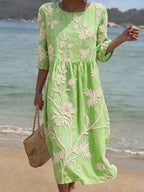Women's relaxed fit embroidered midi dress perfect for summer occasions, featuring delicate floral patterns and a comfortable, breathable fabric ideal for warm weather. 3