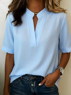 Women's relaxed fit V-neck blouse in a lightweight fabric, perfect for summer wear, featuring short sleeves and a comfortable, casual style ideal for everyday outfits. 0