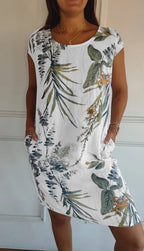 Women's relaxed shift dress featuring a vibrant botanical print, perfect for summer casual wear, designed with convenient side pockets for added functionality. 0
