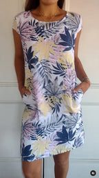 Women's relaxed shift dress featuring a vibrant botanical print, perfect for summer casual wear, designed with convenient side pockets for added functionality. 10