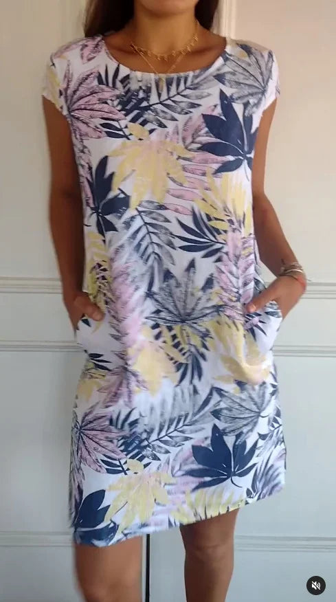 Women's relaxed shift dress featuring a vibrant botanical print, perfect for summer casual wear, designed with convenient side pockets for added functionality. 10