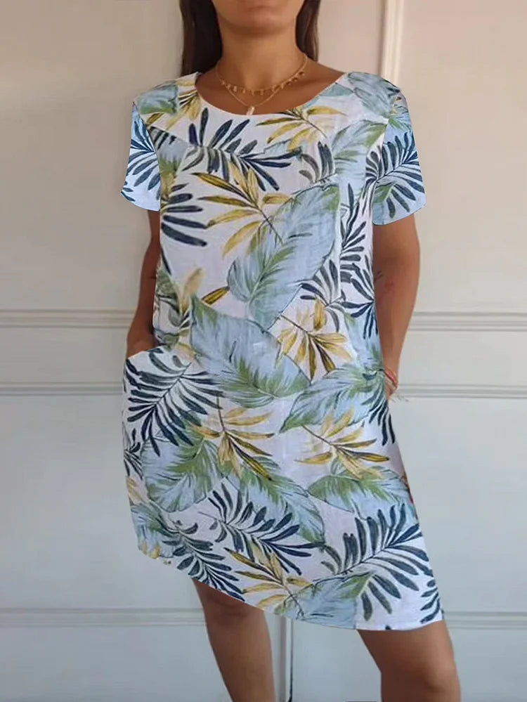 Women's relaxed shift dress featuring a vibrant botanical print, perfect for summer casual wear, designed with convenient side pockets for added functionality. 11