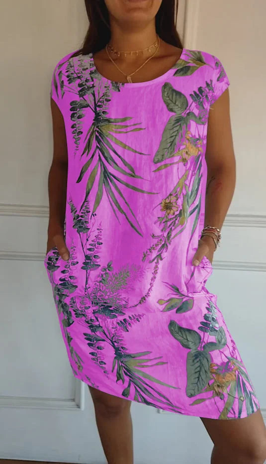 Women's relaxed shift dress featuring a vibrant botanical print, perfect for summer casual wear, designed with convenient side pockets for added functionality. 4
