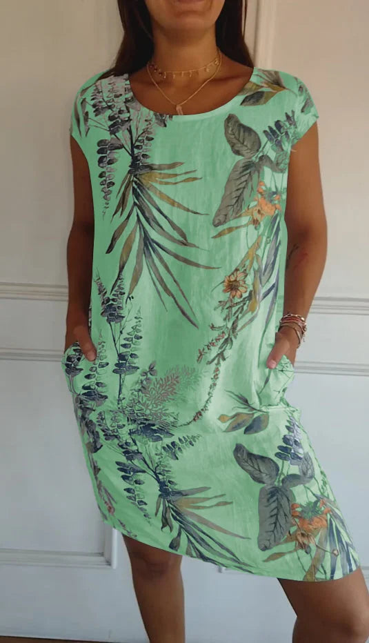 Women's relaxed shift dress featuring a vibrant botanical print, perfect for summer casual wear, designed with convenient side pockets for added functionality. 5