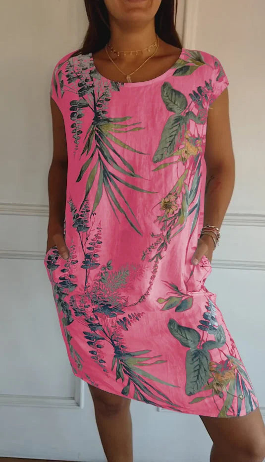 Women's relaxed shift dress featuring a vibrant botanical print, perfect for summer casual wear, designed with convenient side pockets for added functionality. 6