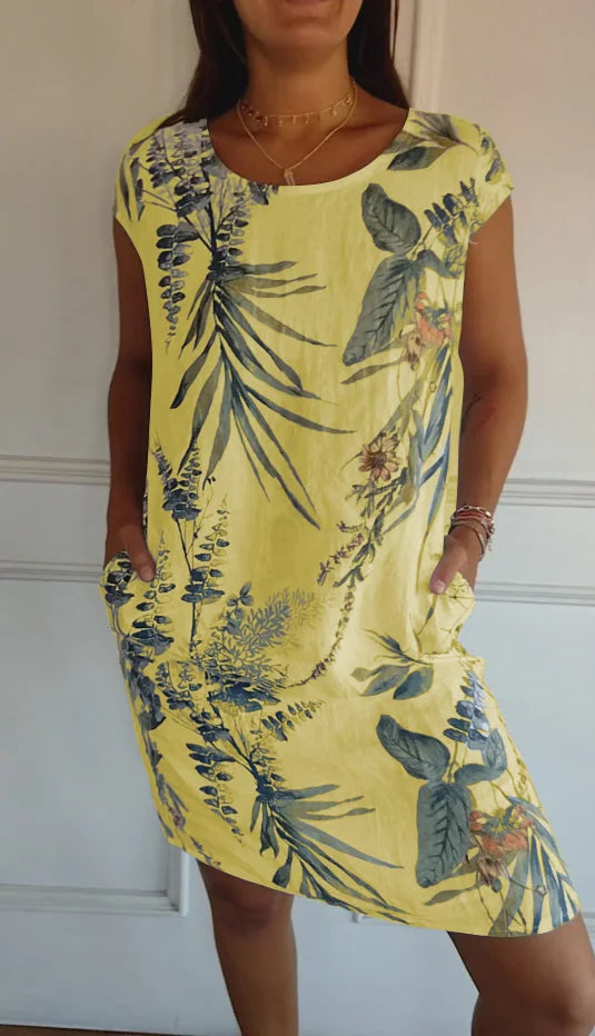 Women's relaxed shift dress featuring a vibrant botanical print, perfect for summer casual wear, designed with convenient side pockets for added functionality. 8