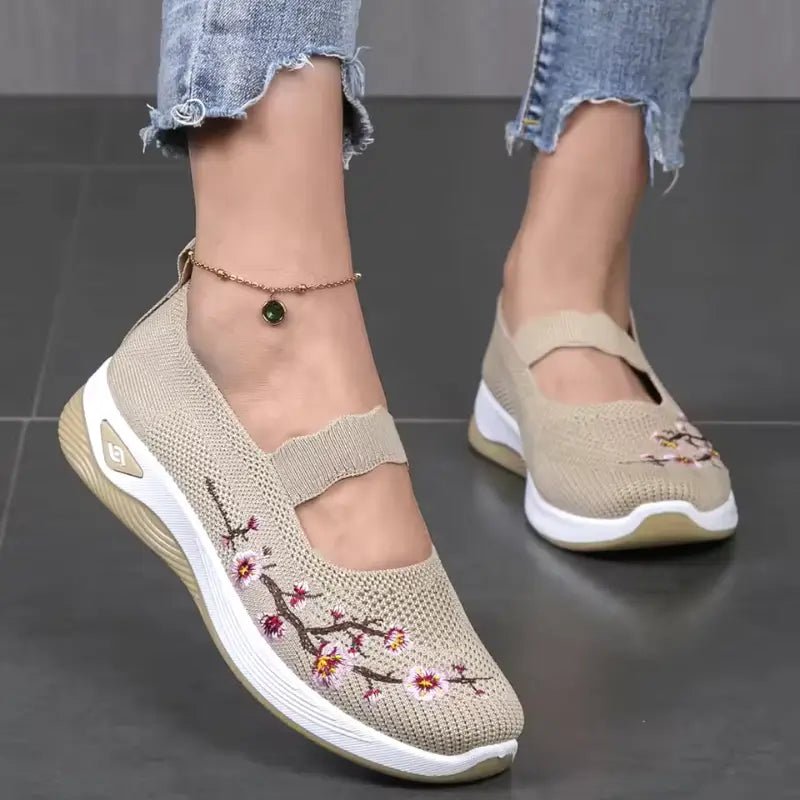 Women's slip-on sneakers featuring a casual comfort design with a vibrant floral pattern, perfect for everyday wear and stylish outings. 10