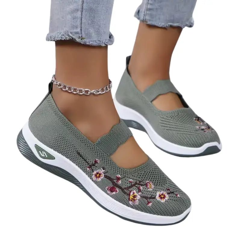 Women's slip-on sneakers featuring a casual comfort design with a vibrant floral pattern, perfect for everyday wear and stylish outings. 9