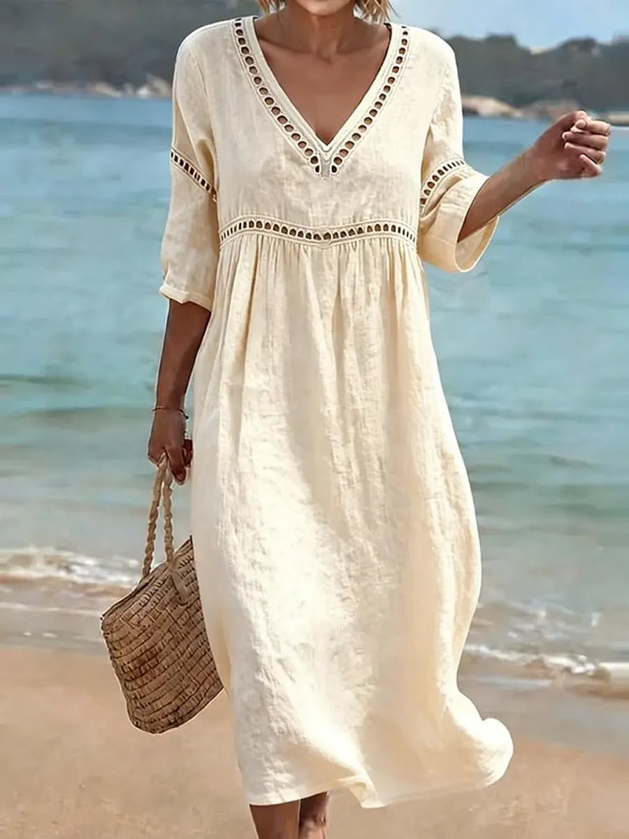 Women's summer V-neck cotton dress featuring a flowy casual style and convenient side pockets, perfect for warm weather outings. 1