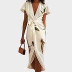 Plus size women's wrap dress featuring a tie waist, designed for formal summer occasions, showcasing a flattering silhouette and elegant style. 1